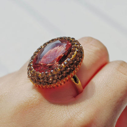 Astralee Jewelry Vintage Zultanite Ring with a large red gemstone on a finger